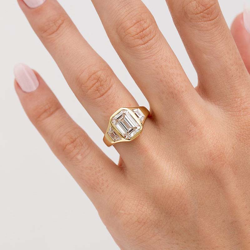 4.5Ct Emerald Cut Three-Stone Bezel Ring in Gold