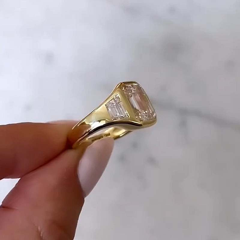 4.5Ct Emerald Cut Three-Stone Bezel Ring in Gold